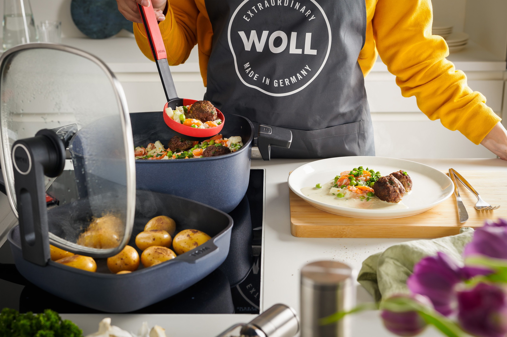 Auf dem Herd steht eine heiße, viereckige Kasserolle aus der Serie Diamond Lite. In dieser wurde ein Wikinigertopf zubereitet. Diese werden mit einer Schöpfkelle der Serie Cock it auf einen Teller platziert. In einer viereckigen, heißen Diamond Lite Pfan